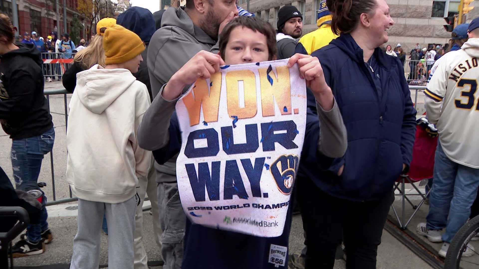Young Brewers fans celebrate during the championship parade in Brookfield.
